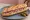 Sandwich au Saucisson: an illustration of pork, butter, pickle and garlic on baguette.