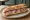 Sandwich au Saucisson de Lyon: an illustration of pork, pistachio and butter on baguette.