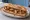 Sandwich aux Grattons Lyonnais: an illustration of pork on baguette.