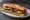 Sandwich aux Légumes Grillés: an illustration of eggplant, bell pepper, olive oil and garlic on baguette.