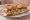 Sandwich aux Rillettes: an illustration of pork and pickle on baguette.