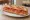 Sandwich aux Tomates: an illustration of tomato, butter, pepper and olive oil on baguette.