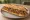 Sandwich Axoa: an illustration of veal, pepper, onion, garlic and more on baguette.