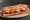 Sandwich Basque: an illustration of pepper, butter and tomato on baguette.