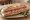 Sandwich Bierwurst: an illustration of butter, mustard and pickle on baguette.