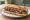 Sandwich Bordelais: an illustration of beef, onion, butter, parsley and more on baguette.