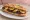 Sandwich Boudin Noir aux Pommes: an illustration of apple, butter, onion and pepper on baguette.