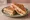 Sándwich Caliente: an illustration of ham, cheese, butter and tomato.