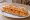 Sandwich Carottes Râpées: an illustration of carrot, mayonnaise, lemon, parsley and more on baguette.