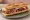Sandwich Charcuterie Corse: an illustration of capicola and butter on baguette.