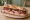 Sandwich Charcuterie Corse Mixte: an illustration of capicola and pickle on baguette.