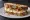Sandwich Chèvre-Miel: an illustration of goat cheese, honey, walnuts and butter.