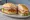 Sándwich Cordobés: an illustration of ham, pork, cheese, lettuce and more on baguette.
