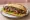 Sándwich de Bife de Chorizo: an illustration of chimichurri, lettuce and tomato on baguette.