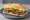 Sándwich de Carne: an illustration of beef, lettuce, tomato and mayonnaise on baguette.