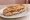 Sandwich de Comptoir: an illustration of ham, butter and pickle on baguette.