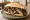Sándwich de Cordero: an illustration of lamb, chimichurri and onion on baguette.