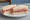 Sándwich de Fiambres: an illustration of ham, salami, mortadella, cheese and more on white bread.