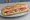 Sandwich de la Boulangerie: an illustration of ham, butter and pickle on baguette.