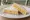 Sándwich de Miga de Choclo: an illustration of corn, cheese and butter on white bread.