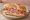 Sándwich de Mortadela: an illustration of mortadella, cheese and mayonnaise on baguette.