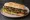 Sándwich de Parrilla: an illustration of beef, chimichurri, lettuce and tomato on baguette.