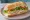 Sándwich de Pechuga: an illustration of chicken, lettuce, tomato and mayonnaise on baguette.