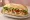 Sándwich de Pechuga Grillada: an illustration of chicken, lettuce, tomato and mayonnaise on baguette.