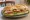 Sándwich de Pollo Grillado: an illustration of chicken, lettuce, tomato and mayonnaise on baguette.