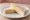 Sándwich de Queso: an illustration of cheese and butter on white bread.