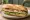Sándwich de Trucha: an illustration of lemon, butter and lettuce on baguette.