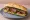 Sándwich de Vacío: an illustration of beef, chimichurri, lettuce and tomato on baguette.
