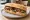 Sándwich de Verduras Grilladas: an illustration of eggplant, pepper, onion and olive oil on baguette.