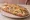 Sandwich Ficelle Picarde: an illustration of ham, mushroom, gruyère and butter on baguette.