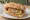 Sandwich Fleischnacka: an illustration of pork, beef, onion, parsley and more on baguette.