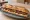 Sandwich Gendarme: an illustration of butter, mustard and pickle on baguette.