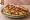 Sandwich Grec: an illustration of lamb, potato, lettuce, tomato and more.
