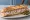 Sandwich Grenier Médocain: an illustration of butter, pickle and mustard on baguette.