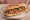 Sandwich Languedocien: an illustration of tomato, olive oil, garlic and parsley on baguette.