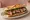 Sandwich Magret de Canard: an illustration of duck, fig, arugula and butter on baguette.
