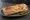 Sandwich Moutarde de Dijon: an illustration of ham, butter and pickle on baguette.