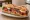 Sandwich Niçois: an illustration of tuna, anchovy, egg, tomato and more on baguette.