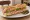 Sandwich Parisien Classique: an illustration of ham, butter, pickle and pepper on baguette.