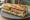 Sandwich Pâté de Campagne: an illustration of pâté, pickle, butter and pepper on baguette.