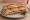 Sandwich Pâté en Croûte: an illustration of pork, pickle, mustard, butter and more on baguette.