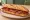 Sandwich Perpignanais: an illustration of pork, chorizo, tomato, pepper and more on baguette.