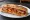 Sandwich Piperade: an illustration of ham, egg, tomato, pepper and more on baguette.
