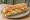 Sandwich Poulet-Crudités: an illustration of chicken, lettuce, tomato, carrot and more on baguette.