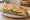 Sandwich Poulet: an illustration of chicken, mayonnaise, lettuce, tomato and more on baguette.