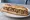 Sandwich Rillettes de Canard: an illustration of duck, pickle and pepper on baguette.
